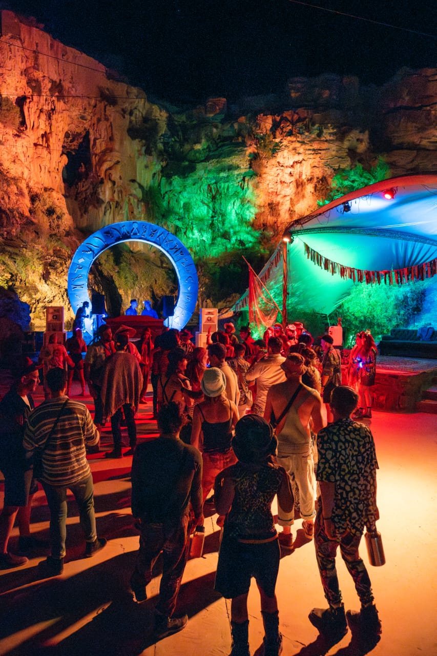 Crowd gathered at the canyon entrance with glowing arch